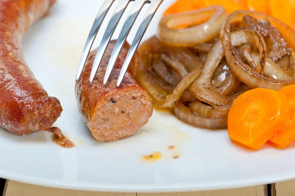 Beef sausages cooked on iron skillet — Stock Photo, Image