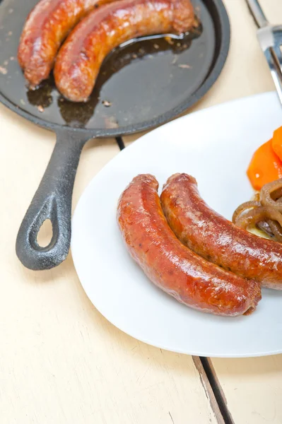 Beef sausages cooked on iron skillet — Stock Photo, Image