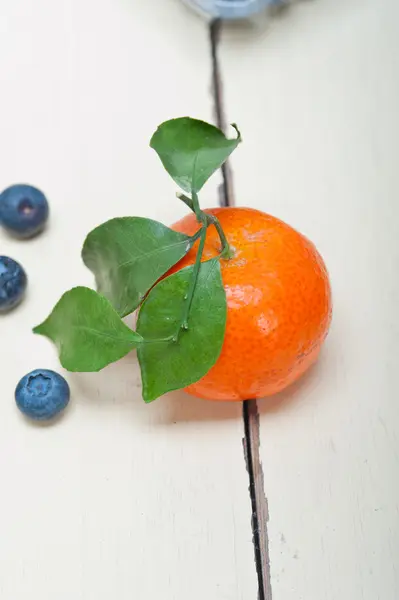 Tangerine and blueberry on white table — Stock Photo, Image