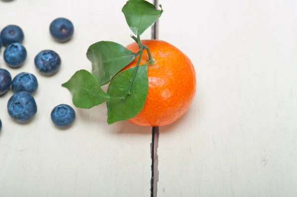 Tangerine and blueberry on white table — Stock Photo, Image