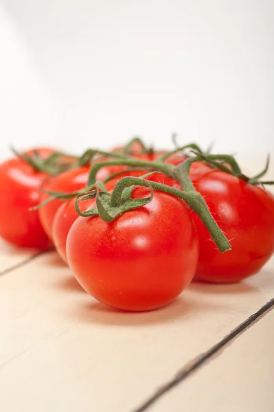 Fresh cherry tomatoes on a cluster — Stock Photo, Image