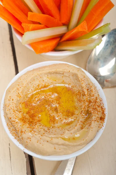 Fresh hummus dip with raw carrot and celery — Stock Photo, Image