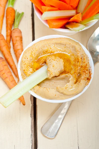 Fresh hummus dip with raw carrot and celery — Stock Photo, Image