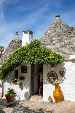 Alberobello, İtalya - 16 Eylül 2019: Trulli köyünde geleneksel beyaz evler. Alberobello, İtalya. Yapım tarzı İtalya 'nın Apulia bölgesindeki Murge bölgesine özgüdür (İtalyan Puglia bölgesinde). Kireç taşı ve temel taştan yapılmış..