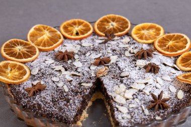 Haşhaş tohumlu tart ve üzerine toz şeker serpiştirilmiş meyve.