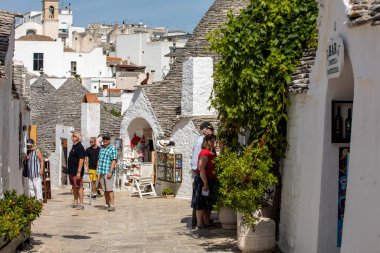 Alberobello, İtalya - 16 Eylül 2019: Halk Alberobello, İtalya 'daki Trulli köyünü ziyaret etti. Yapım tarzı İtalya 'nın Apulia bölgesindeki Murge bölgesine özgüdür (İtalyan Puglia bölgesinde). Kireç taşı ve temel taştan yapılmış..