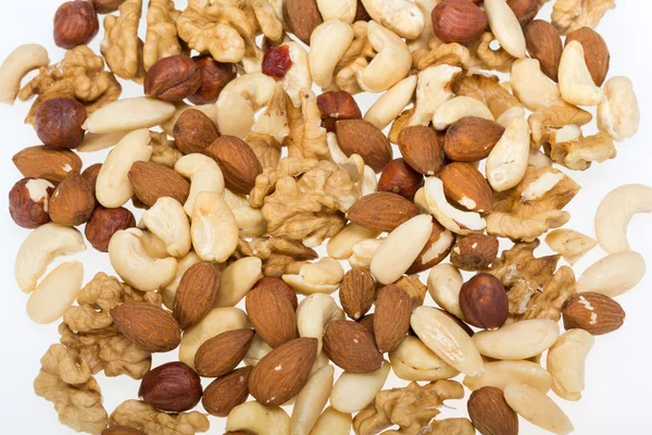 Frutos secos mezclados avellanas, nueces, anacardos, piñones aislados sobre fondo blanco —  Fotos de Stock