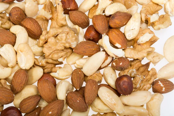 Hintergrund gemischter Nüsse - Haselnüsse, Walnüsse, Cashewnüsse, Pinienkerne — Stockfoto