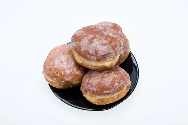 Whole donuts on the black porcelain plate — Stock Photo, Image