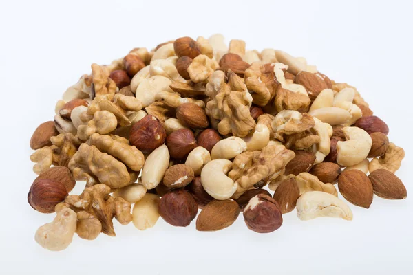 Mixed nuts  -  hazelnuts, walnuts, cashews,  pine nuts isolated on white background — Stock Photo, Image