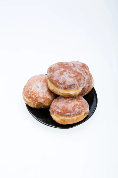 Whole donuts on the black porcelain plate — Stock Photo, Image