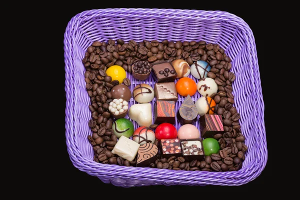 Set of a various chocolate pralines and coffee beans in lavender basket — Stock Photo, Image