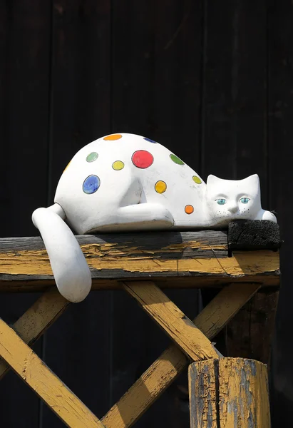 Colorful porcelain cat on wooden balcony — Stock Photo, Image