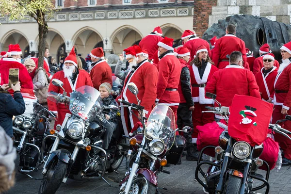 The parade of Santa Clauses on motorcycles around the Main Market Square in Cracow. Poland — Stock Photo, Image