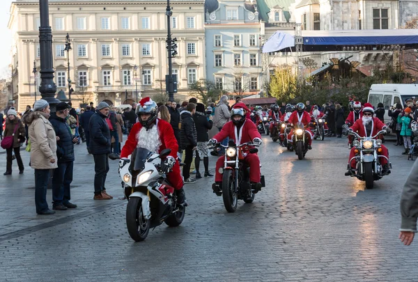 The parade of Santa Clauses on motorcycles around the Main Market Square in Cracow. Poland — Stock Photo, Image
