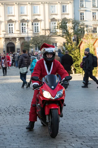 The parade of Santa Clauses on motorcycles around the Main Market Square in Cracow. Poland — Stock Photo, Image