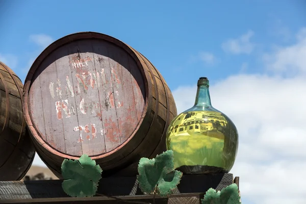 Barrels and  big bottles with grape wine - malvasia.  Lanzarote, Spain — Stock Photo, Image