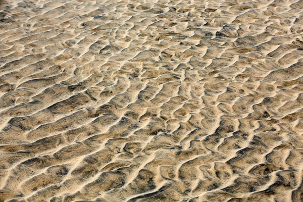 Närbild av sandmönster av en strand på sommaren — Stockfoto