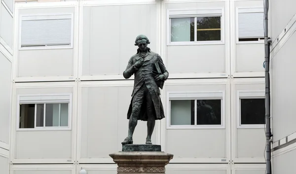 Paris - Quai de Conti -Statue of Nicholas de Concordet 1894 by Jacques Perrin surrounded through builders' huts — Stock Photo, Image