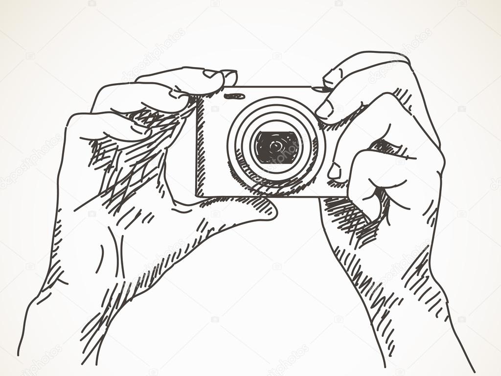 Hands with compact photo camera