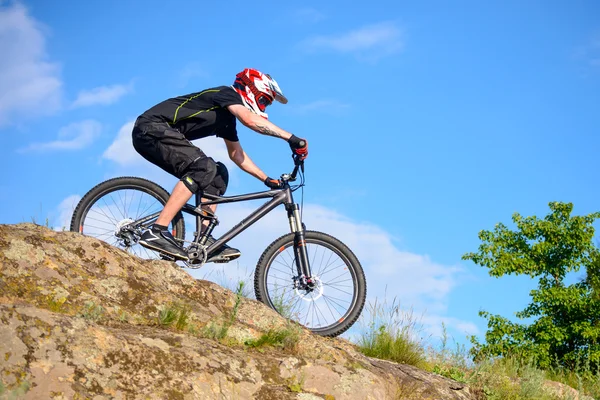 Ciclista profesional montando la bicicleta en el hermoso sendero de montaña de primavera. Deportes extremos —  Fotos de Stock