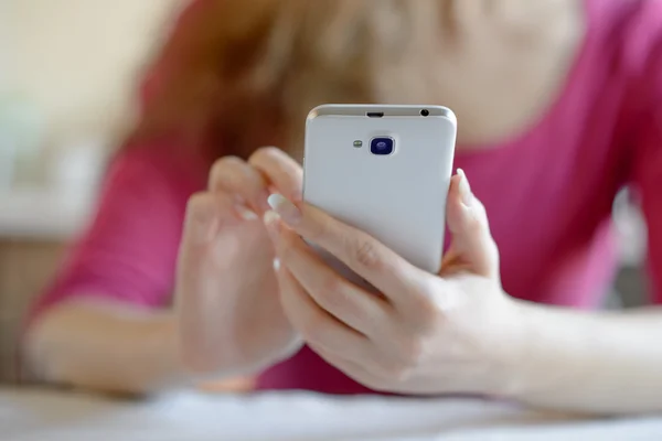 Vrouw met behulp van haar mobiele slimme telefoon thuis — Stockfoto