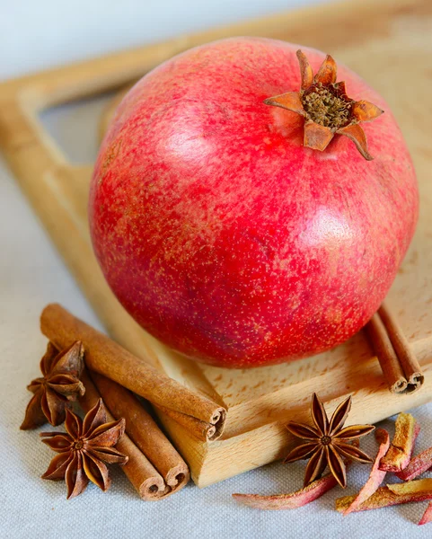 Red Pomegranate with Spaces on the Wooden Cutting Board — Stock Photo, Image