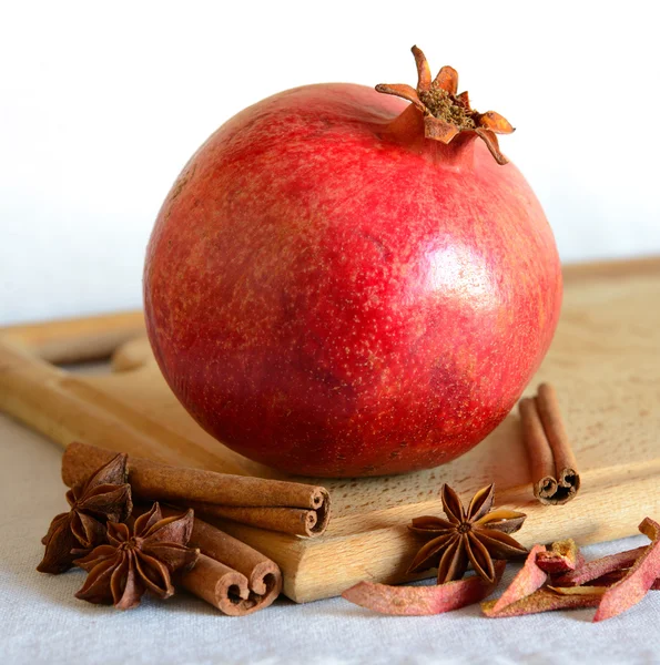 Red Pomegranate with Spaces on the Wooden Cutting Board — Stock Photo, Image