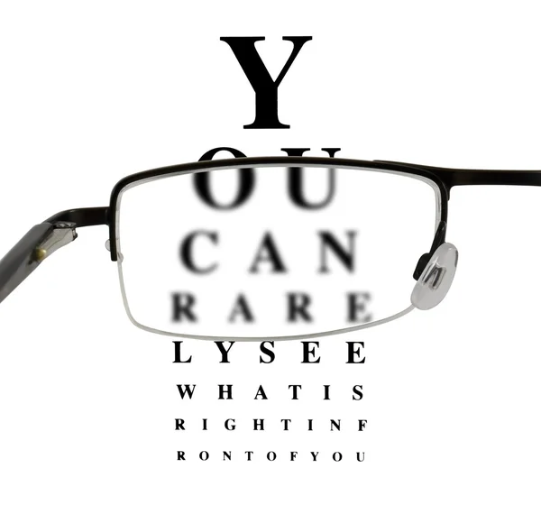 Eyeglass with humorous eyetest chart Rechtenvrije Stockfoto's