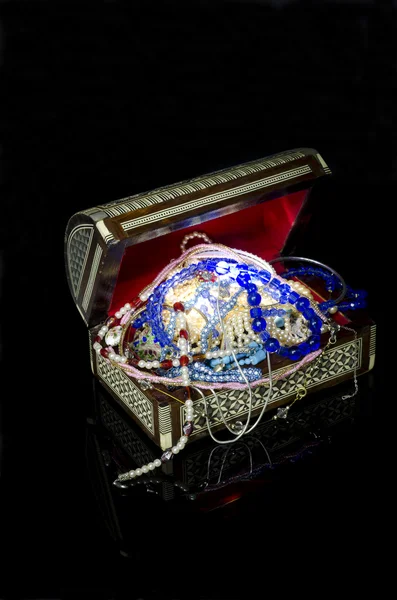 Inlay decorated old wooden box full of jewelry