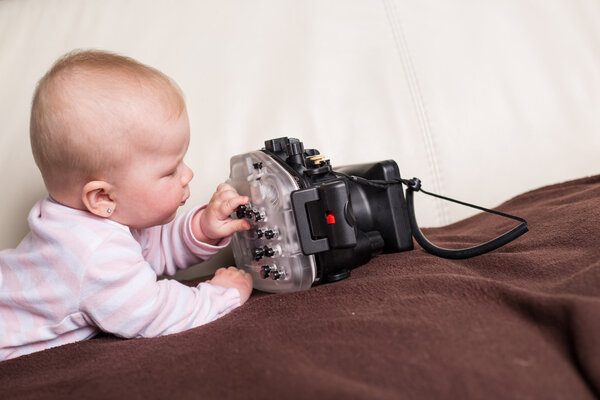 Baby playing with underwater camera