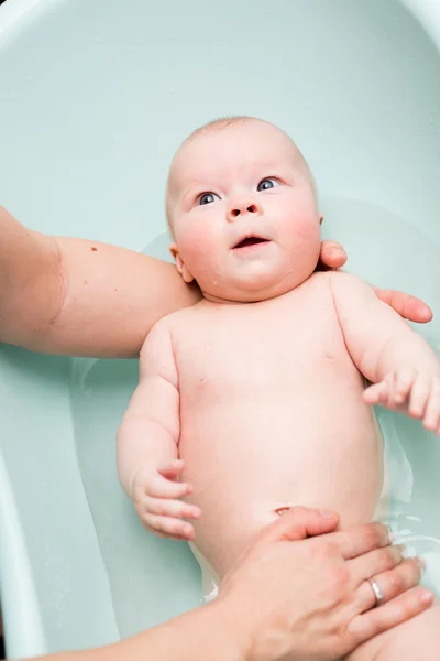 Baby girl taking a bath Stock Image