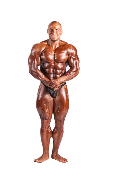 Bodybuilder biegt sich — Stockfoto