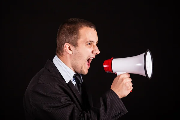 Businessman screaming in megaphone — Stock Photo, Image