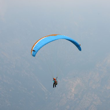 Paraglider flying at Lake Garda clipart