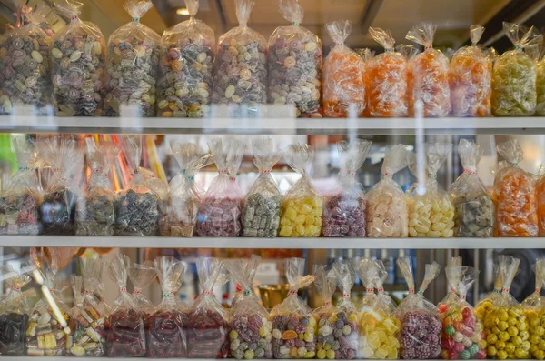 Packets with candys  in a shop window — Stock Photo, Image