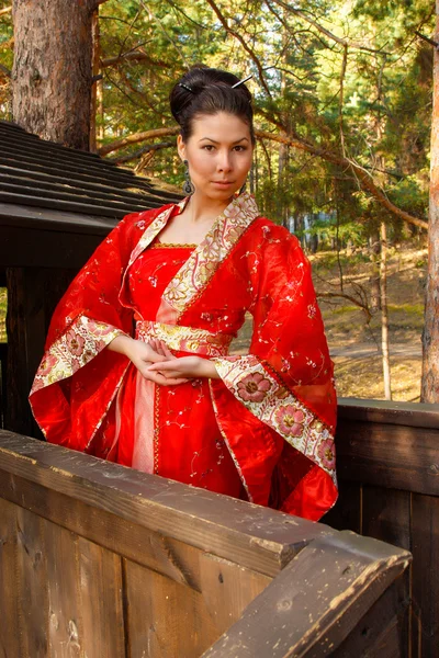 Portrait of a woman in Chinese princess costume in the pine forest — Stock Photo, Image