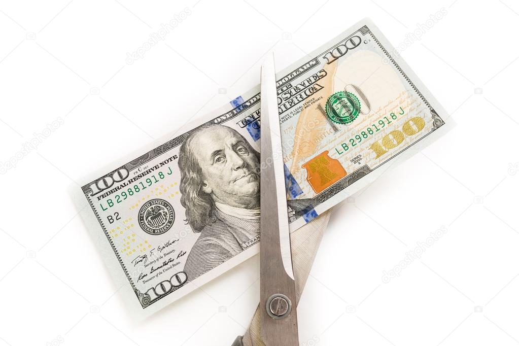 Dollars are cutting with scissors on a white background.