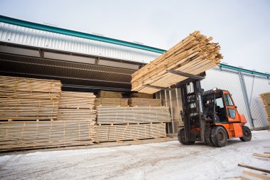 folk lift truck in wood factory clipart