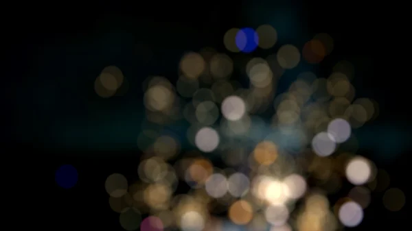 Foto de luzes bokeh no fundo preto — Fotografia de Stock