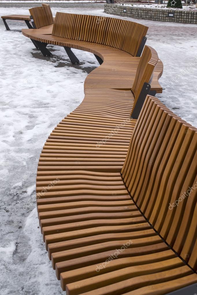 Modern Curved S Shaped Brown Wooden Bench Outdoor Stock Photo