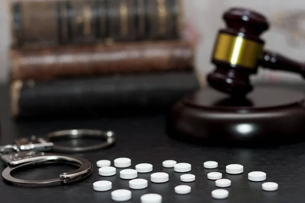 stock image Judge's gavel with handcuffs, drugs on wooden table, drugs concept