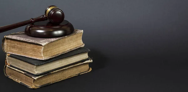 Law concept - law book with a wooden judges gavel on table in a courtroom or law enforcement office. Copy space for text