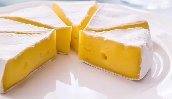 Yellow cheese on a plate — Stock Photo, Image