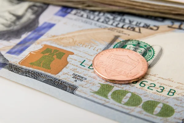 US Currency with one dollar coins — Stock Photo, Image