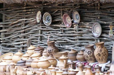 Products made of red clay. Pottery of different sizes exhibited  clipart