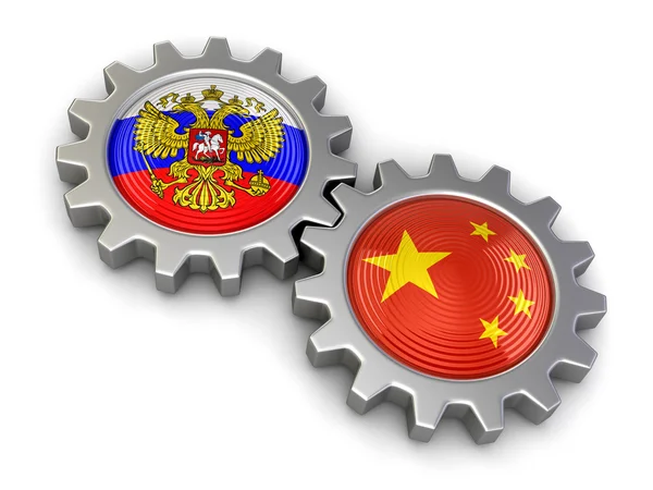 Drapeaux russes et chinois sur un engrenage (chemin de coupe inclus ) — Photo