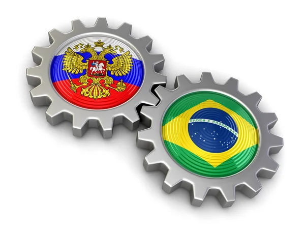 Drapeaux russes et brésiliens sur un engrenage (chemin de coupe inclus ) — Photo