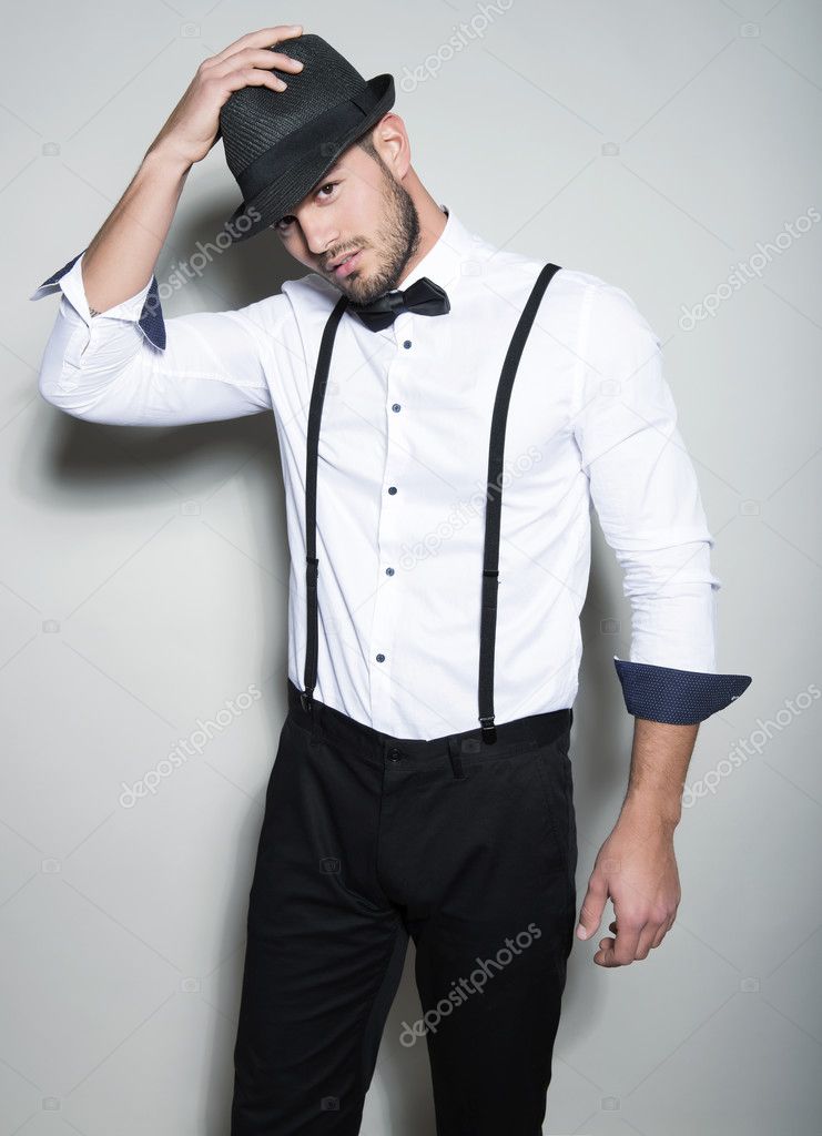 handsome young man in suit on grey background