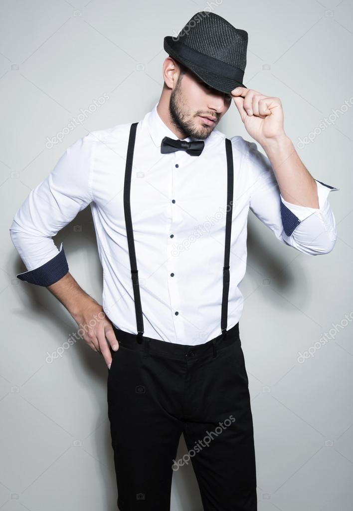 handsome young man in suit on grey background